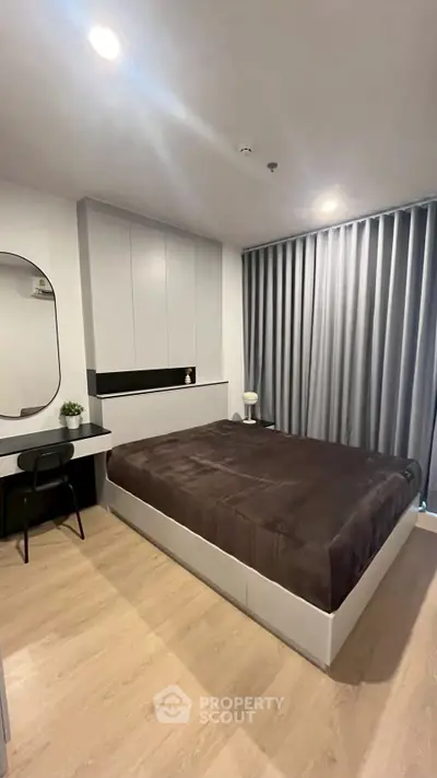 Modern bedroom with sleek design, featuring a large bed and stylish decor.