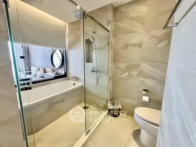 Luxurious modern bathroom with glass shower and elegant bathtub