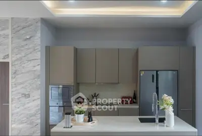 Modern kitchen with sleek appliances and stylish marble accents