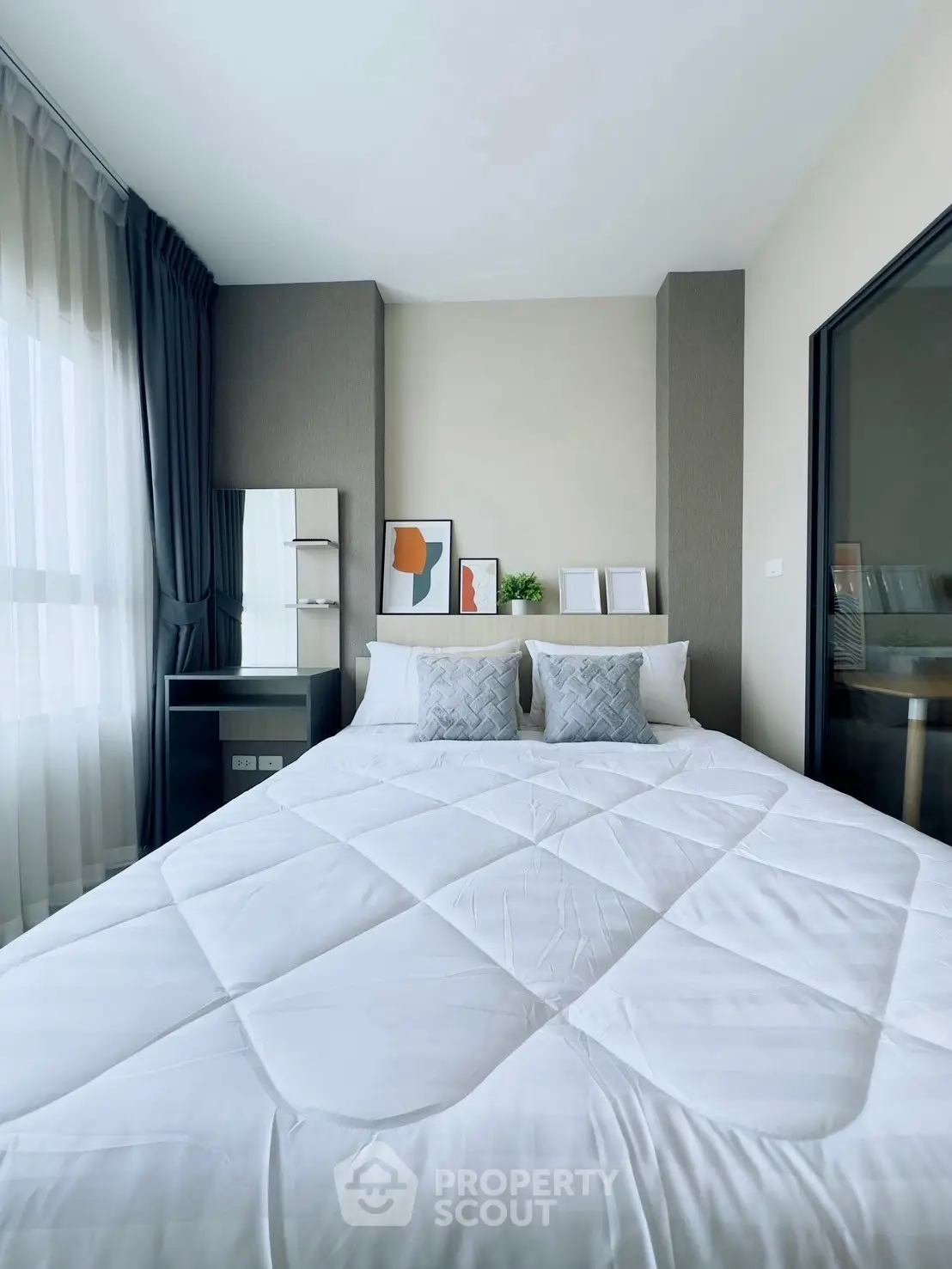 Modern bedroom with stylish decor and large window for natural light