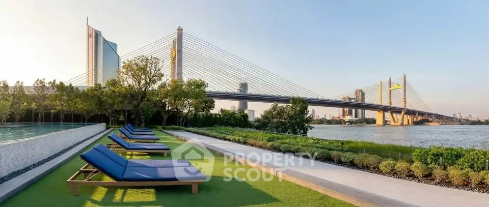 Luxurious riverside property with stunning bridge view and relaxing poolside lounge area.