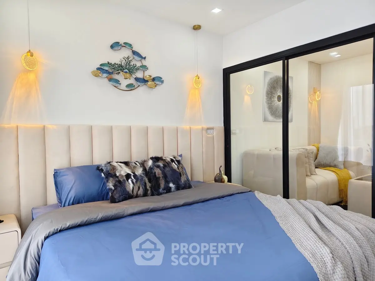 Luxurious bedroom with plush bedding and modern decor, featuring elegant lighting and stylish wall art.