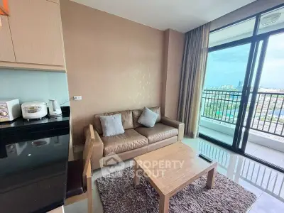 Modern living room with cozy sofa and stunning city view from large balcony.