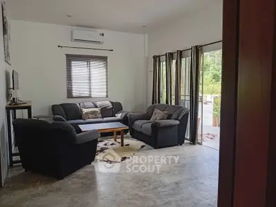 Cozy living room with modern furniture and natural light, perfect for relaxation.