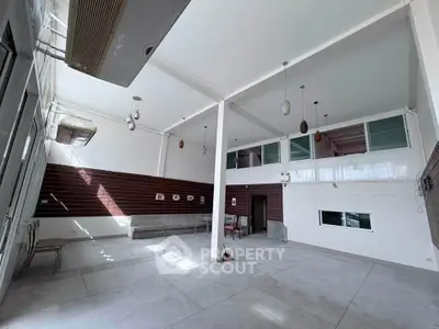 Spacious modern interior with high ceilings and ample natural light, perfect for versatile living or commercial use.