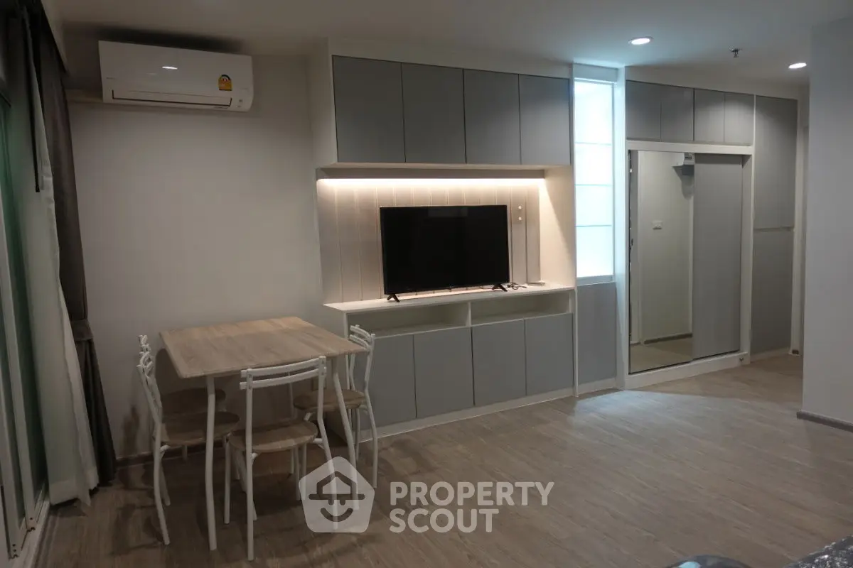 Modern living room with sleek cabinetry and wall-mounted TV