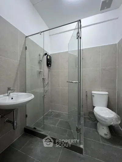 Modern bathroom with glass shower enclosure and sleek fixtures