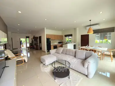 Spacious open-plan living room with modern furniture and natural light