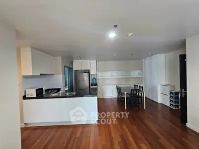 Spacious open-layout kitchen and dining area with modern appliances and wooden flooring