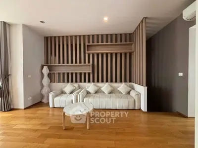 Modern living room with stylish wood paneling and elegant white sofa, perfect for contemporary living.