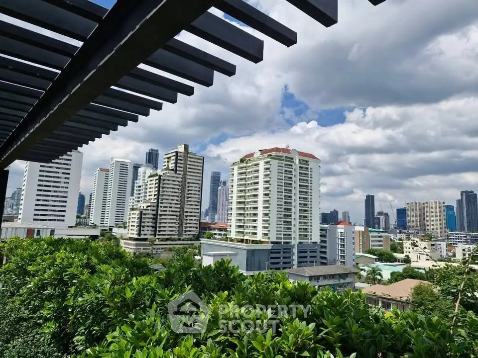 Stunning cityscape view from a lush rooftop garden with modern high-rise buildings under a vibrant sky.