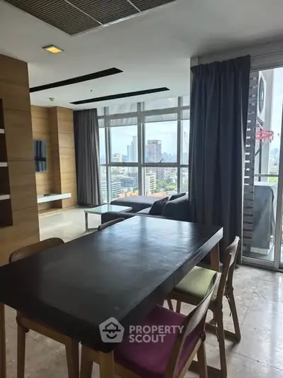 Modern living room with city view and stylish dining area