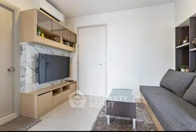 Modern living room with sleek furniture and wall-mounted TV in a stylish apartment.