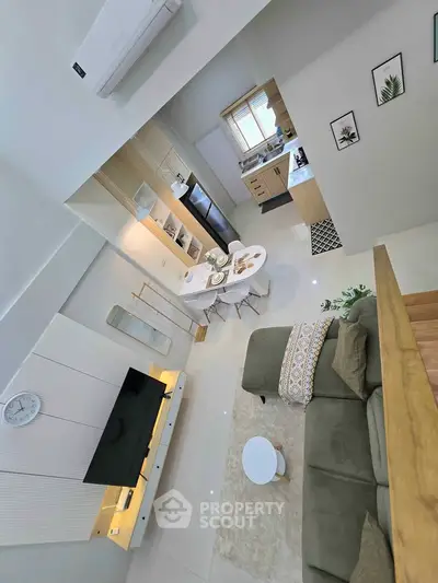 Modern open-plan living room with stylish kitchen and cozy dining area
