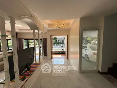Elegant living room with chandelier and open view to garden