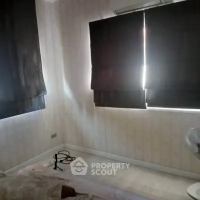 Cozy bedroom with dark curtains and air conditioning unit