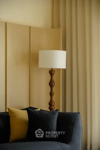Elegant living room with modern lamp and stylish sofa, perfect for cozy evenings.