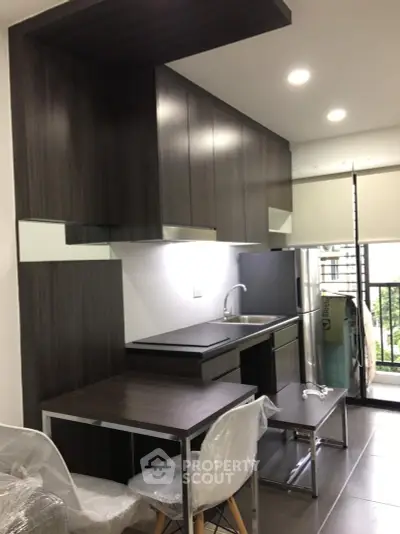 Modern kitchen with sleek dark cabinetry and open layout design