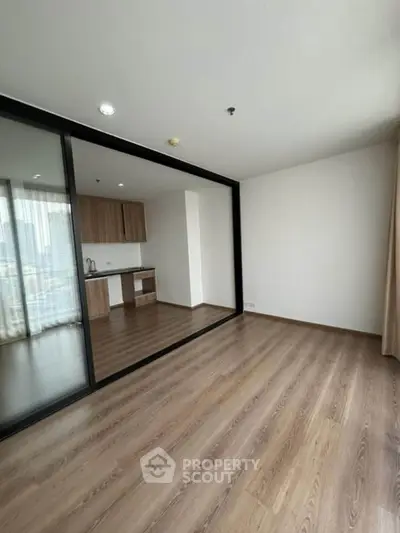 Spacious modern apartment with open layout and sleek kitchen design, featuring large windows for natural light.