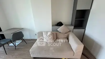 Modern living room with cozy beige sofa and sleek dining area