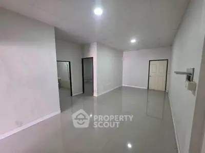 Spacious empty room with glossy tiled floor and bright lighting, ideal for customization.