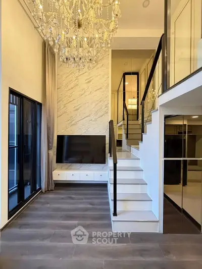 Luxurious modern living room with high ceiling and elegant chandelier