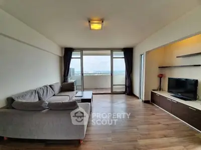 Spacious living room with modern decor and balcony view