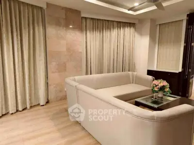 Elegant living room with modern beige sofa and stylish decor