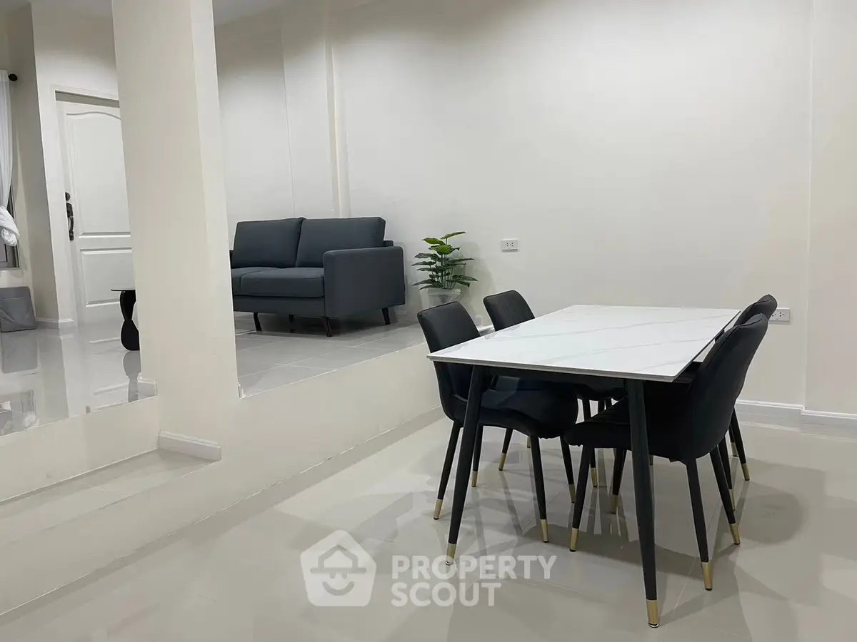 Modern dining area with sleek table and chairs in a stylish open layout