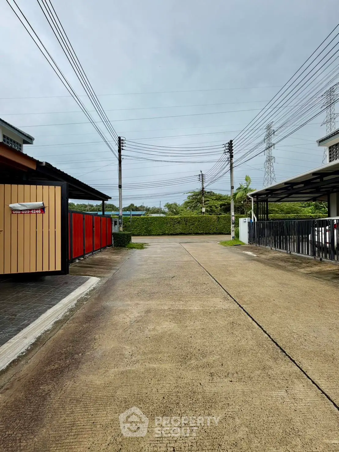 Spacious outdoor parking area with covered spaces and clear sky view.
