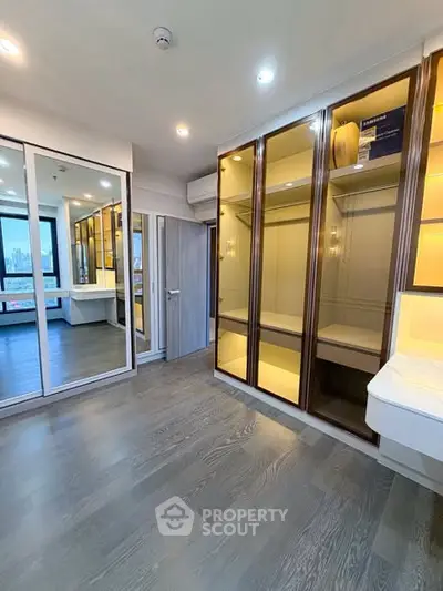 Spacious modern bedroom with built-in wardrobe and city view window