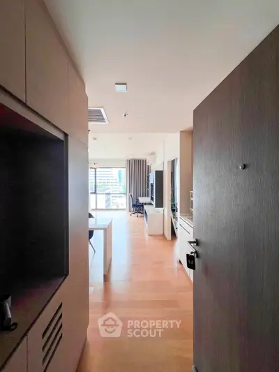 Modern open-plan apartment with wooden flooring and city view