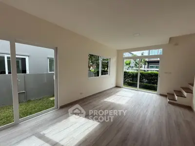 Spacious living room with large windows and garden view in modern home