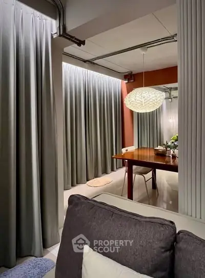 Modern dining area with stylish lighting and elegant curtains