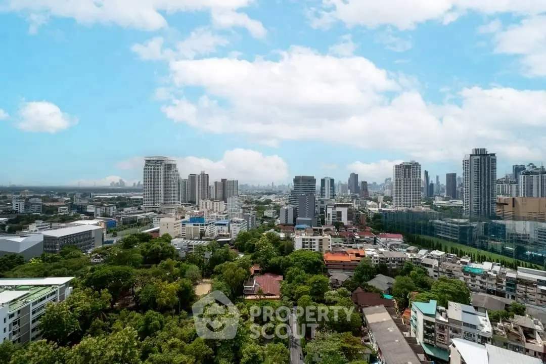 Stunning cityscape view with lush greenery and modern skyscrapers under a clear blue sky.