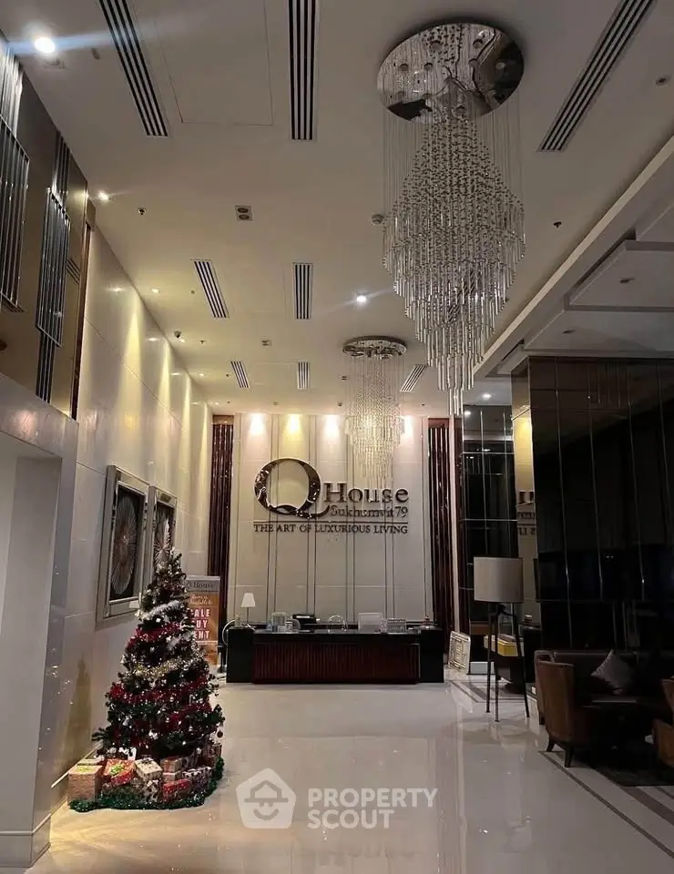 Luxurious condo lobby with elegant chandelier and festive decor