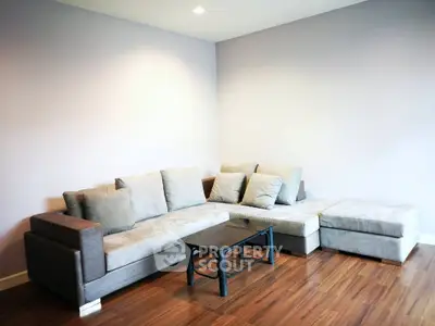 Spacious living room with modern sectional sofa and wooden flooring