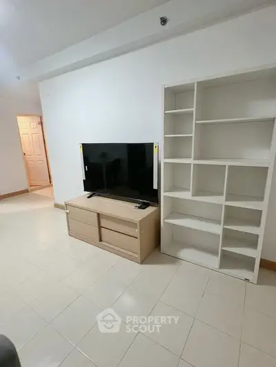 Modern living room with sleek TV stand and spacious shelving unit, perfect for stylish urban living.