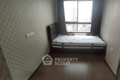 Cozy bedroom with city view, featuring a single bed and modern decor.