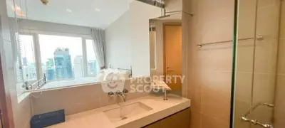 Modern bathroom with city view, featuring sleek fixtures and large mirror, perfect for urban living.