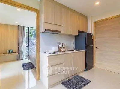 Modern kitchen with sleek cabinetry and open layout in a stylish apartment