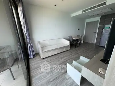 Modern living room with sleek furniture and large windows in a stylish apartment.