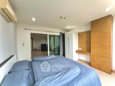 Spacious bedroom with modern decor and ample natural light