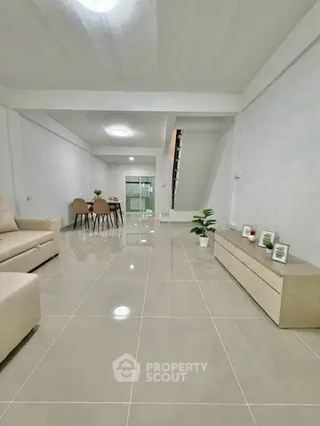 Spacious modern living room with sleek tile flooring and minimalist decor