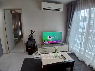 Modern living room with TV, air conditioning, and golf clubs near balcony.
