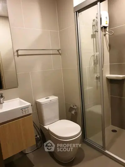 Modern bathroom with sleek shower and compact design, perfect for urban living.