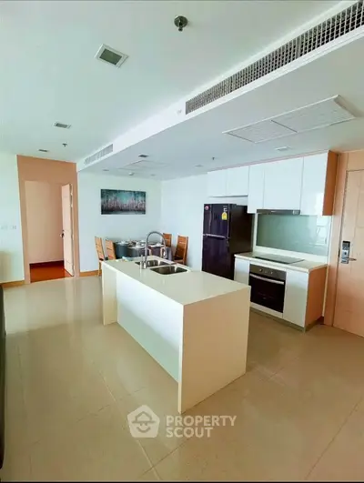 Modern kitchen with island and dining area in open layout apartment