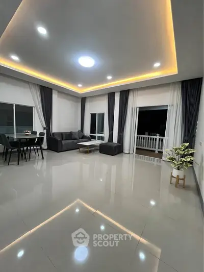 Spacious modern living room with elegant lighting and sleek furniture