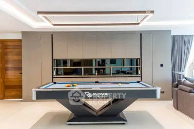 Luxurious living room with modern pool table and elegant decor