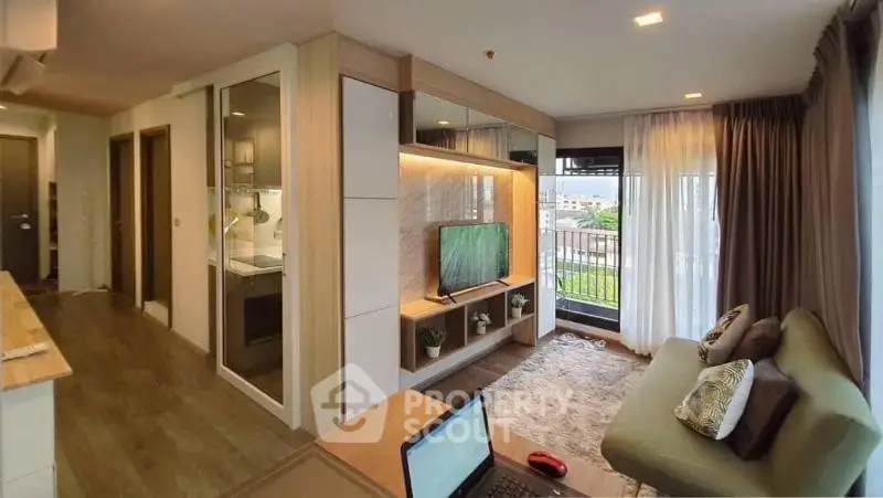 Modern living room with balcony view, stylish decor, and open layout in a contemporary apartment.